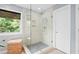 Bright bathroom featuring a glass walk-in shower with white subway tile and pebble floor at 1820 Hunters Moon Dr, Alpharetta, GA 30005