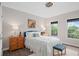 Cozy bedroom with two windows, wood-look flooring, and ceiling fan at 1820 Hunters Moon Dr, Alpharetta, GA 30005