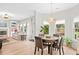 Open concept dining area with adjacent living room and natural light at 1820 Hunters Moon Dr, Alpharetta, GA 30005
