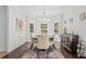 Charming dining room with chandelier, wainscoting and views to backyard at 1820 Hunters Moon Dr, Alpharetta, GA 30005