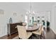 Elegant dining area with hardwood floors, chandelier and easy access to living room at 1820 Hunters Moon Dr, Alpharetta, GA 30005