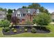 Beautiful two-story brick home with manicured landscaping, showcasing curb appeal and outdoor charm at 1820 Hunters Moon Dr, Alpharetta, GA 30005