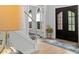 Welcoming foyer with modern light fixture, grand double door, and elegant decor at 1820 Hunters Moon Dr, Alpharetta, GA 30005