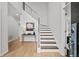 Bright foyer boasts hardwood floors, modern staircase with metal railing, and neutral decor at 1820 Hunters Moon Dr, Alpharetta, GA 30005
