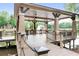 Picturesque gazebo on the pond, offering a tranquil spot with seating and views of the water feature and surrounding greenery at 1820 Hunters Moon Dr, Alpharetta, GA 30005