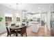 Kitchen with an island and stainless steel appliances, and a dining area with seating for four at 1820 Hunters Moon Dr, Alpharetta, GA 30005