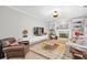 Comfortable living room with built-in shelving, a fireplace, and light wood flooring at 1820 Hunters Moon Dr, Alpharetta, GA 30005