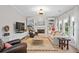 Comfortable living room with built-in shelving, a fireplace, and light wood flooring at 1820 Hunters Moon Dr, Alpharetta, GA 30005