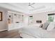 Main bedroom with built-in shelving, fireplace and a modern ceiling fan at 1820 Hunters Moon Dr, Alpharetta, GA 30005