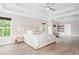 Large main bedroom with tray ceilings, windows, and connected seating area at 1820 Hunters Moon Dr, Alpharetta, GA 30005