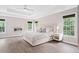 Bright main bedroom with ample windows, fireplace, and a modern ceiling fan at 1820 Hunters Moon Dr, Alpharetta, GA 30005