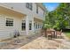 This backyard patio features an outdoor dining table, stone floor, and provides ample space for relaxing and entertaining at 1820 Hunters Moon Dr, Alpharetta, GA 30005