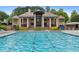 Community pool with a clubhouse, lounge chairs, and well-manicured landscaping, offering a refreshing and luxurious experience at 1820 Hunters Moon Dr, Alpharetta, GA 30005