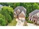 Aerial view of a beautiful brick home with a well-manicured lawn and mature trees at 35 Kenmare Hall Ne, Atlanta, GA 30324