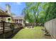 Lush backyard with well-maintained lawn, wooden deck, and cozy patio seating area at 35 Kenmare Hall Ne, Atlanta, GA 30324