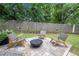 Cozy backyard features a stone patio, modern chairs, and a charming fire pit at 35 Kenmare Hall Ne, Atlanta, GA 30324