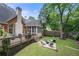 Beautiful backyard boasts a deck, screened porch, fire pit, and mature trees at 35 Kenmare Hall Ne, Atlanta, GA 30324