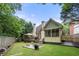 Large backyard features lush greenery, a wooden deck, and a screened-in porch at 35 Kenmare Hall Ne, Atlanta, GA 30324