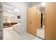 Bright bathroom featuring a tub, dual sinks, custom cabinets, and access to the walk-in closet at 35 Kenmare Hall Ne, Atlanta, GA 30324