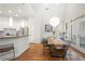 Stylish dining area adjacent to kitchen with modern lighting and outdoor view at 35 Kenmare Hall Ne, Atlanta, GA 30324