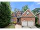 Charming brick home with manicured lawn and a two-car garage on a sunny day at 35 Kenmare Hall Ne, Atlanta, GA 30324