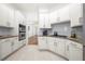 Modern kitchen with white cabinets, granite countertops, and stainless steel appliances at 35 Kenmare Hall Ne, Atlanta, GA 30324