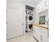 Laundry room featuring stacked washer and dryer and wood countertop at 35 Kenmare Hall Ne, Atlanta, GA 30324
