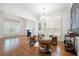 Bright living room featuring hardwood floors, a fireplace, and modern furnishings under a decorative chandelier at 35 Kenmare Hall Ne, Atlanta, GA 30324