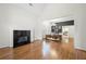Spacious living area with hardwood flooring, fireplace, and open access to the dining area at 35 Kenmare Hall Ne, Atlanta, GA 30324