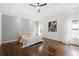 Bright main bedroom features hard wood floors and large windows with decorative curtains at 35 Kenmare Hall Ne, Atlanta, GA 30324