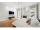 Cozy main bedroom offering a fireplace, hardwood floors, and access to a private outdoor space at 35 Kenmare Hall Ne, Atlanta, GA 30324