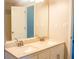 Bathroom featuring a double vanity with granite countertop, large mirror, and white cabinets at 4016 Meadow Glen Way, Fairburn, GA 30213