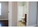 View from hallway of bathroom with tub/shower, wood-look flooring, and wood vanity at 4016 Meadow Glen Way, Fairburn, GA 30213