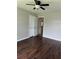 Bedroom features a closet with double doors, a ceiling fan and dark wood-look floors at 4016 Meadow Glen Way, Fairburn, GA 30213
