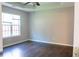 Bedroom featuring a ceiling fan, tray ceiling and large window at 4016 Meadow Glen Way, Fairburn, GA 30213