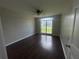 This bedroom has hardwood floors, neutral walls, and a large window for natural light at 4016 Meadow Glen Way, Fairburn, GA 30213
