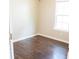 Bright bedroom features a window providing natural light and dark wood-look flooring at 4016 Meadow Glen Way, Fairburn, GA 30213