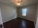 This bedroom offers hardwood floors, neutral walls, a ceiling fan and a window for natural light at 4016 Meadow Glen Way, Fairburn, GA 30213
