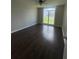 Spacious bedroom with a ceiling fan, large window for ample light, and wood-look flooring at 4016 Meadow Glen Way, Fairburn, GA 30213