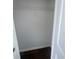 Open walk-in closet featuring a wire shelf and dark wood-look flooring at 4016 Meadow Glen Way, Fairburn, GA 30213