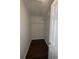 Walk-in closet with wood-look flooring and a white wire shelving system at 4016 Meadow Glen Way, Fairburn, GA 30213