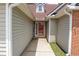 Close-up of the home's entrance showing siding and brick details leading to the front door at 4016 Meadow Glen Way, Fairburn, GA 30213