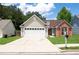 Charming home showcasing a blend of siding and brick accents, complimented by a well-manicured front yard at 4016 Meadow Glen Way, Fairburn, GA 30213