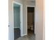 Hallway with neutral paint, wood-look tile floors leading to a bathroom at 4016 Meadow Glen Way, Fairburn, GA 30213