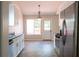 Bright kitchen featuring stainless steel appliances, white cabinetry and modern wood-look tile flooring at 4016 Meadow Glen Way, Fairburn, GA 30213