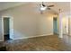 Open living room features wood flooring, a modern ceiling fan, and versatile space for furniture arrangement at 4016 Meadow Glen Way, Fairburn, GA 30213