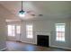 Bright living room with wood floors, a fireplace, and ample windows filling the space with natural light at 4016 Meadow Glen Way, Fairburn, GA 30213