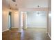 Open-concept living room with wood-look tile flooring, neutral paint and decorative lighting at 4016 Meadow Glen Way, Fairburn, GA 30213