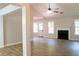 Spacious living room with wood floors, a fireplace, and plenty of natural light from multiple windows at 4016 Meadow Glen Way, Fairburn, GA 30213