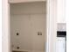 Open utility room or closet with hookups and adjacent to white cabinets at 4016 Meadow Glen Way, Fairburn, GA 30213